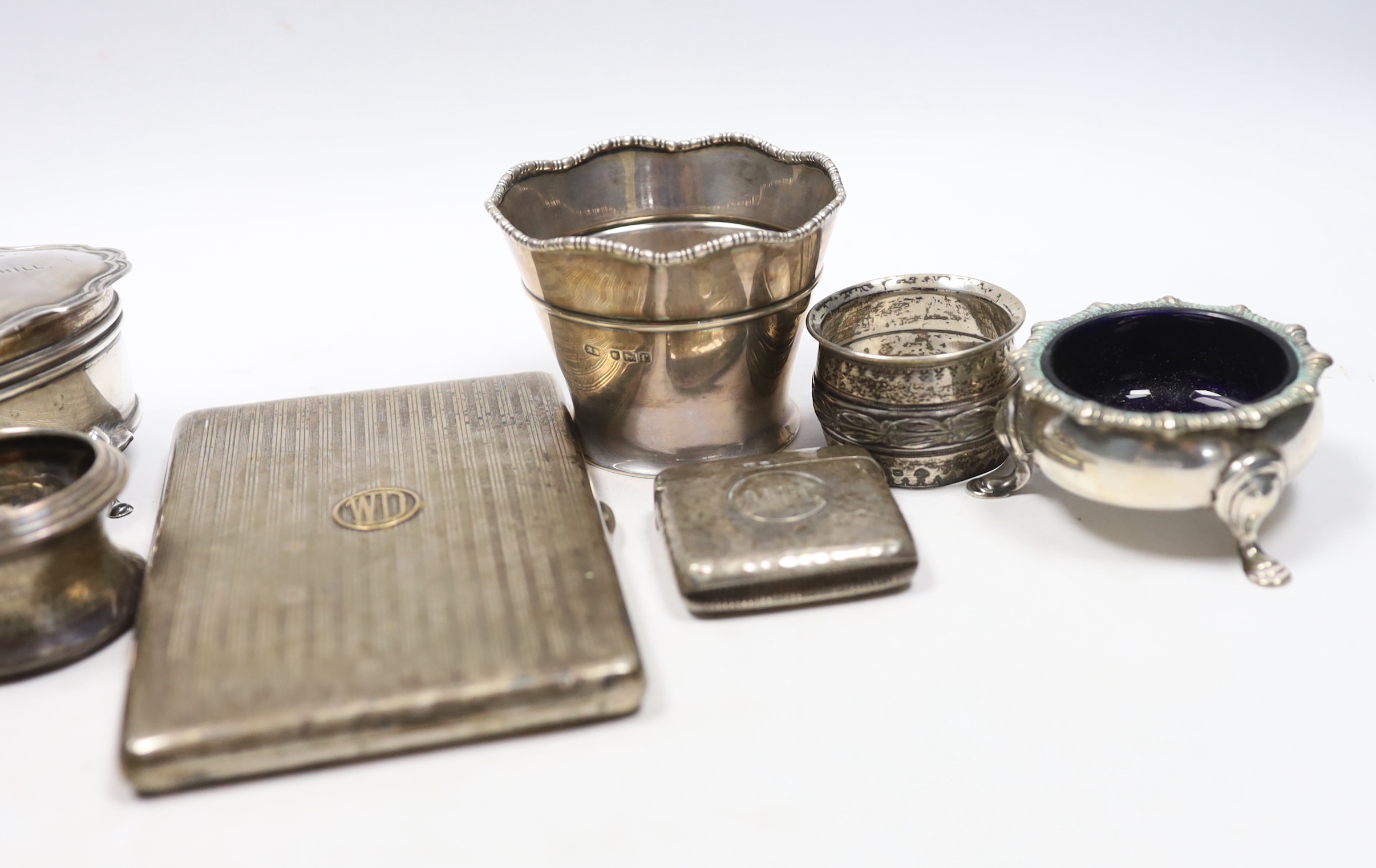 Sundry small silver including an Asprey silver cigarette case, 12.7cm, napkin ring, trinket box, pair of salts, vesta, small vase and a cheroot holder case, together with a plated napkin ring.